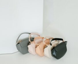 Trois mini sacs alignés, gris, beige et noir, sur fond clair